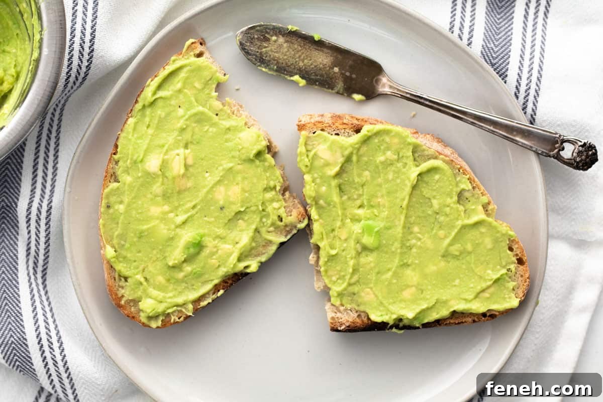 3-Ingredient Dunkin’ Style Avocado Toast Recipe 8 avocado spread on a cut piece of sourdough bread