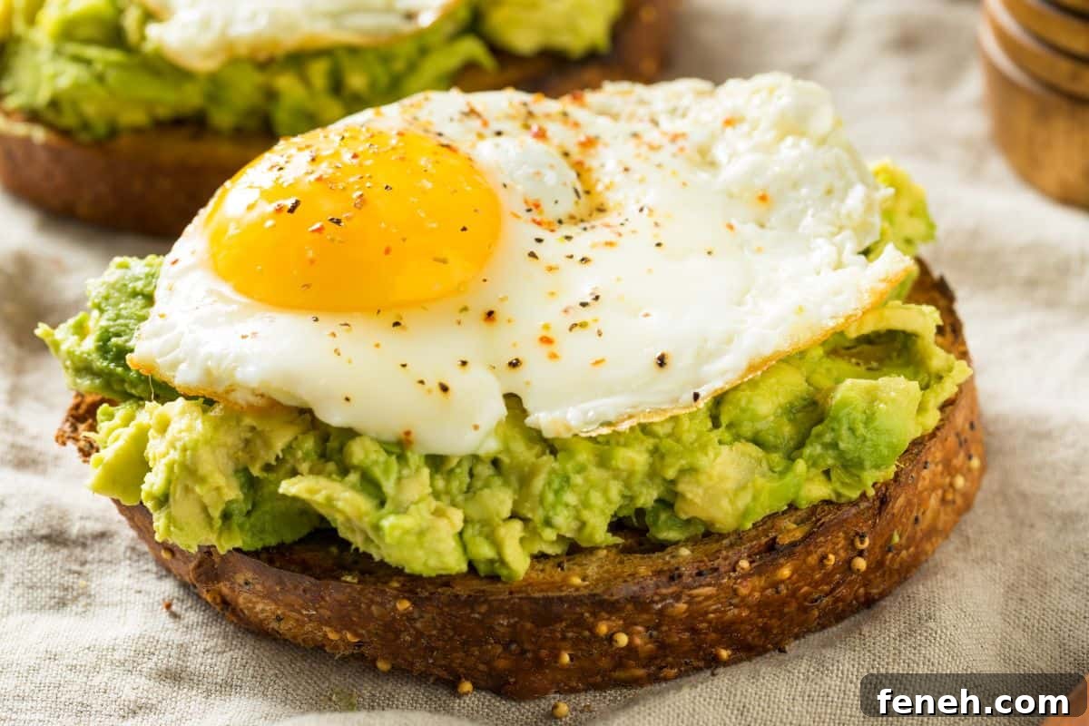 3-Ingredient Dunkin’ Style Avocado Toast Recipe 10 slice of sourdough with avocado spread and a fried egg on top