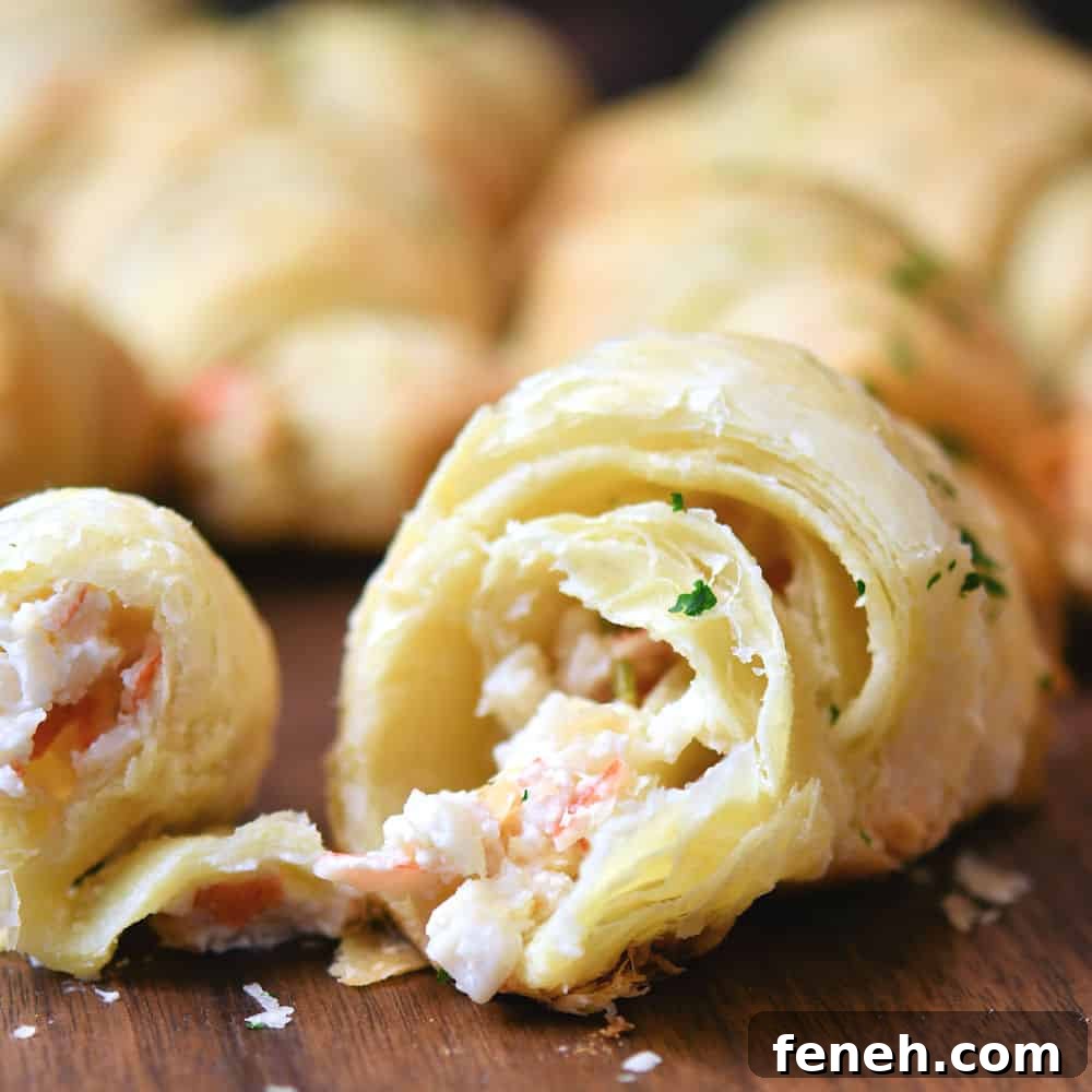 Crescent roll with crab cheese filling, pulled apart at the center to show the filling