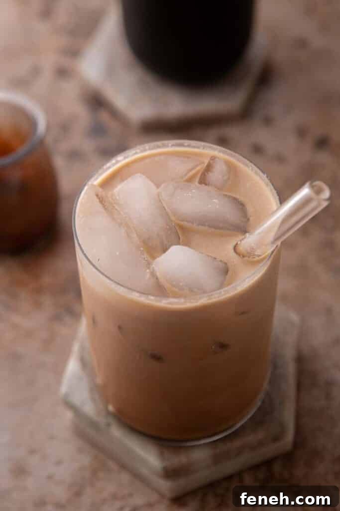 Iced mocha coffee in a glass with a straw coming out of it