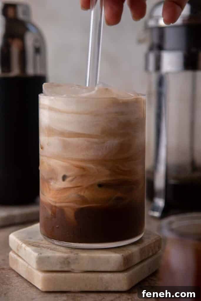 Hand stirring iced mocha coffee