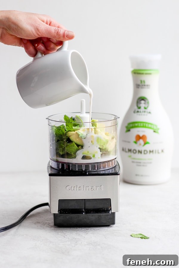 All of the sauce ingredients being added to a food processor.