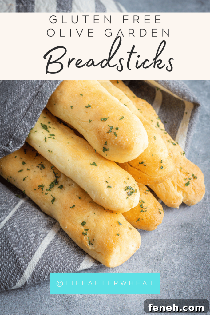 A pinterest friendly image of a stack of breadsticks sprinkled in parsley.