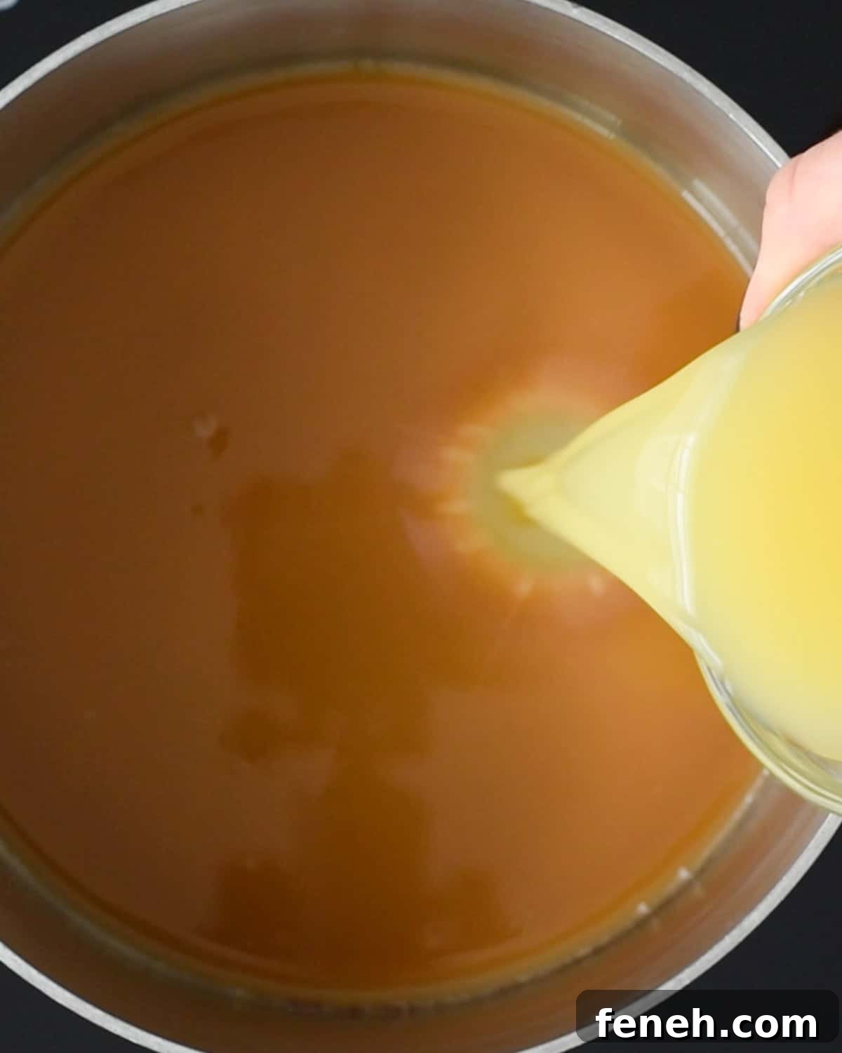 pouring orange juice into the saucepan