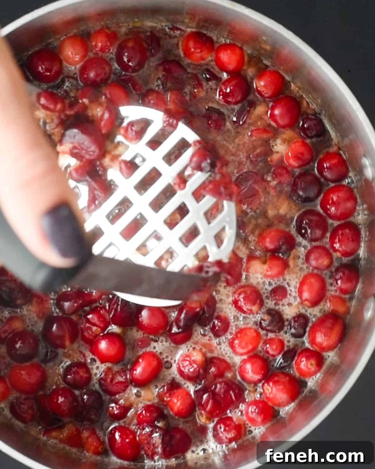 mashing cranberries