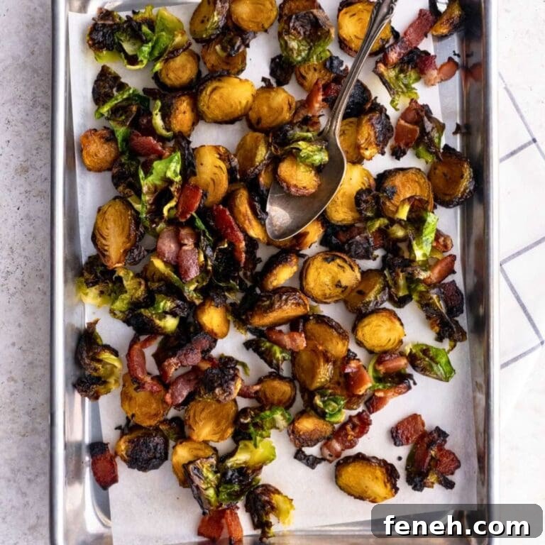 Candied brussels sprouts with bacon on a baking sheet.