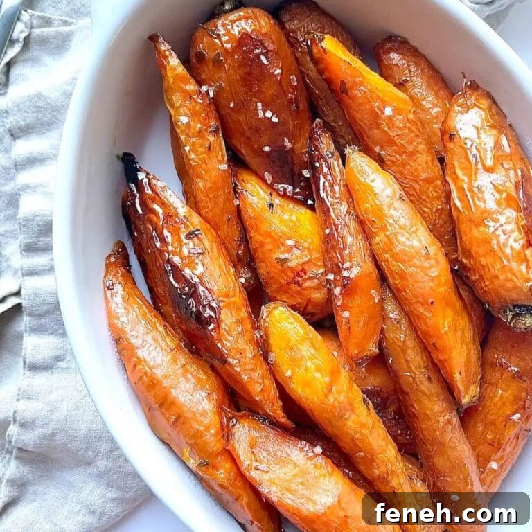 Maple glazed roasted carrots in a white serving dish.