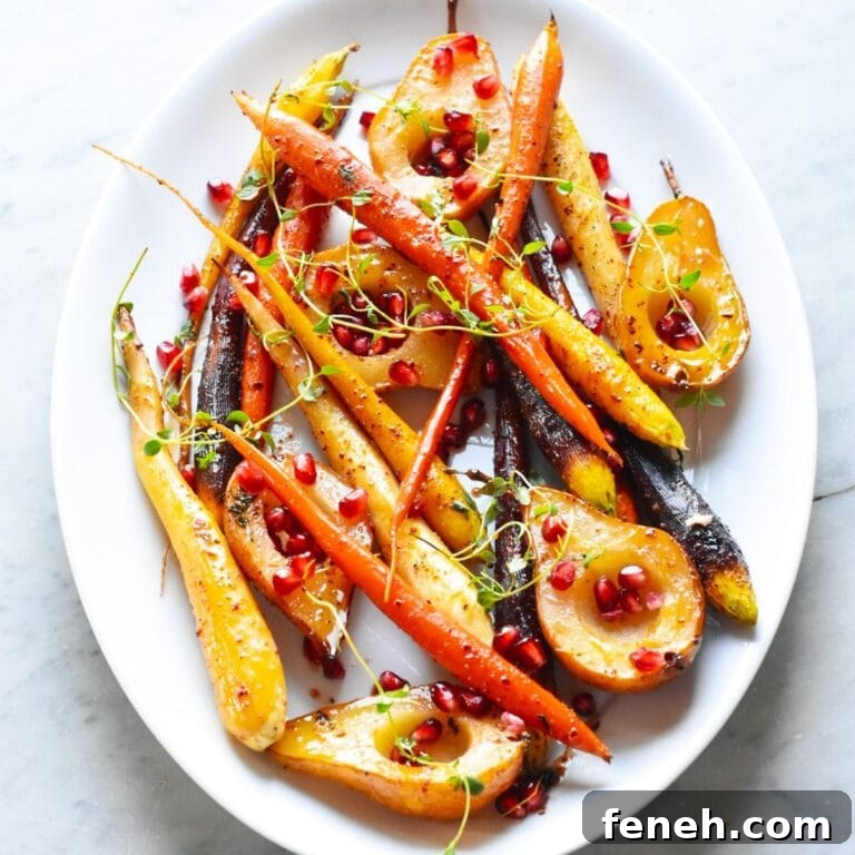 Glazed carrots and pears on a white oval shaped serving platter.