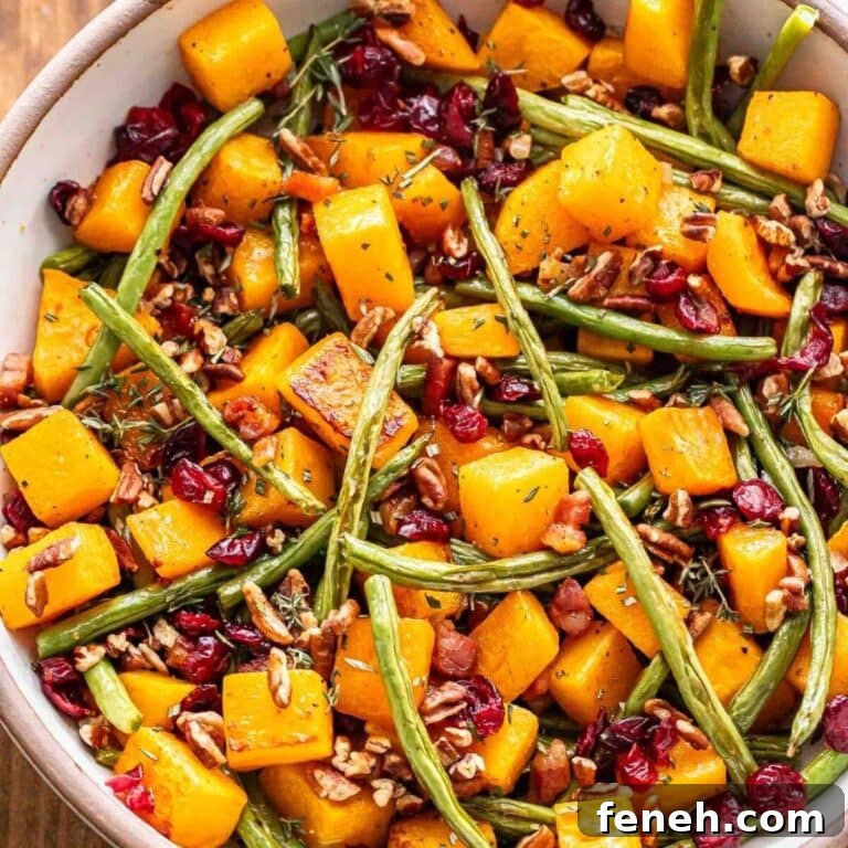 Fall roasted vegetable salad in bowl with butternut squash, green beans, pancetta, dried cranberries and pecans.