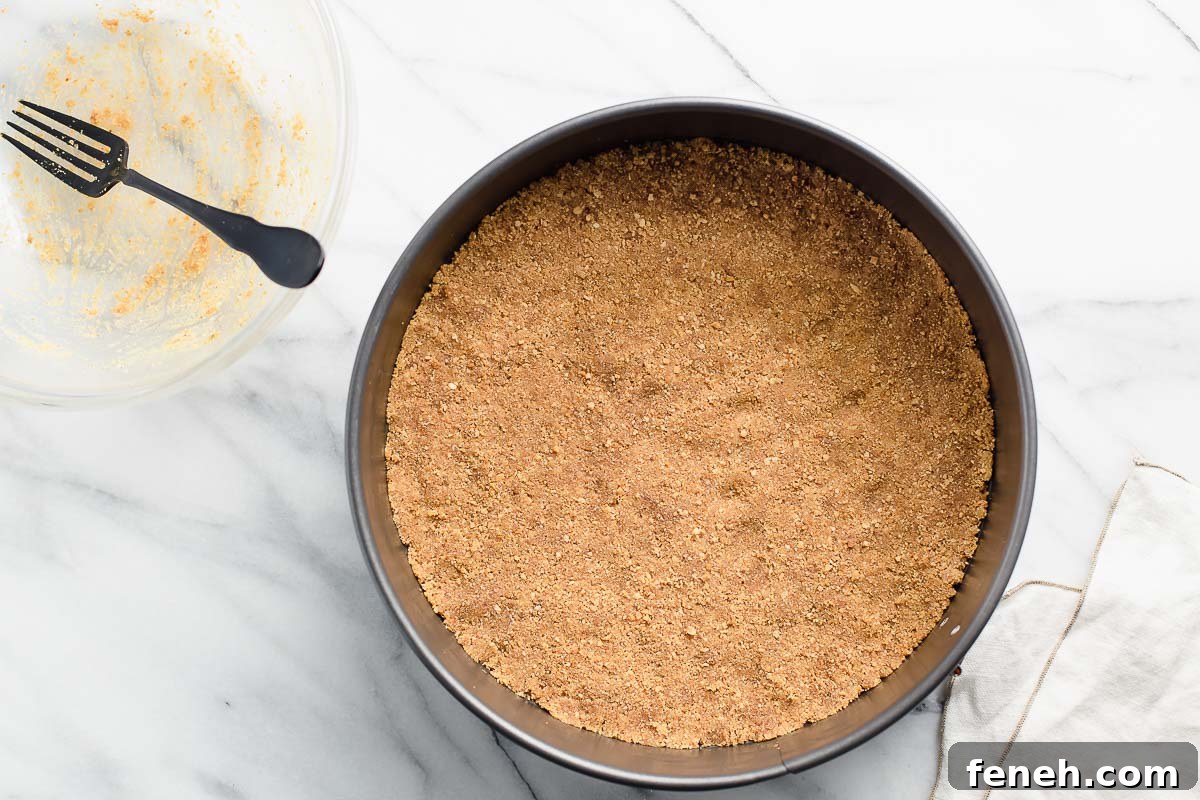 A graham cracker crust pressed into a spring-form pan.