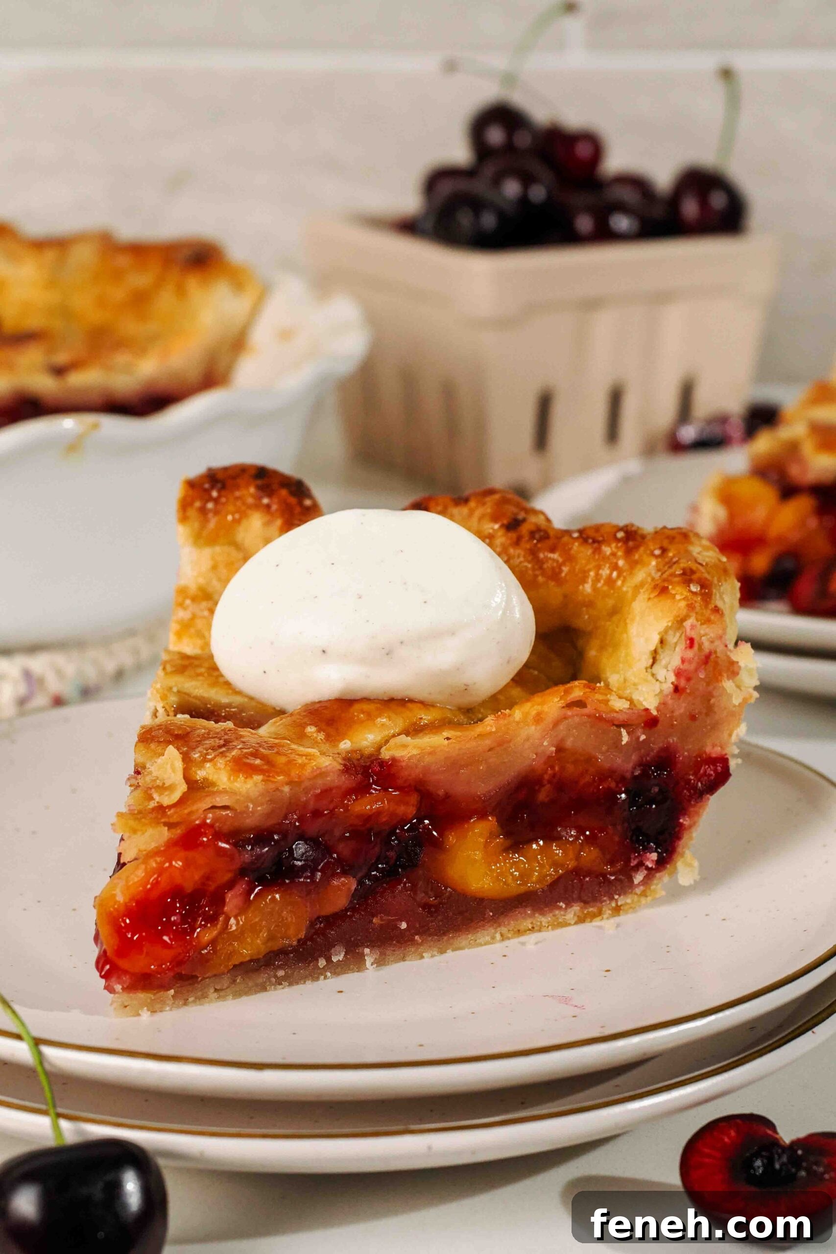 A slice of cherry pie with vanilla whipped cream on top.