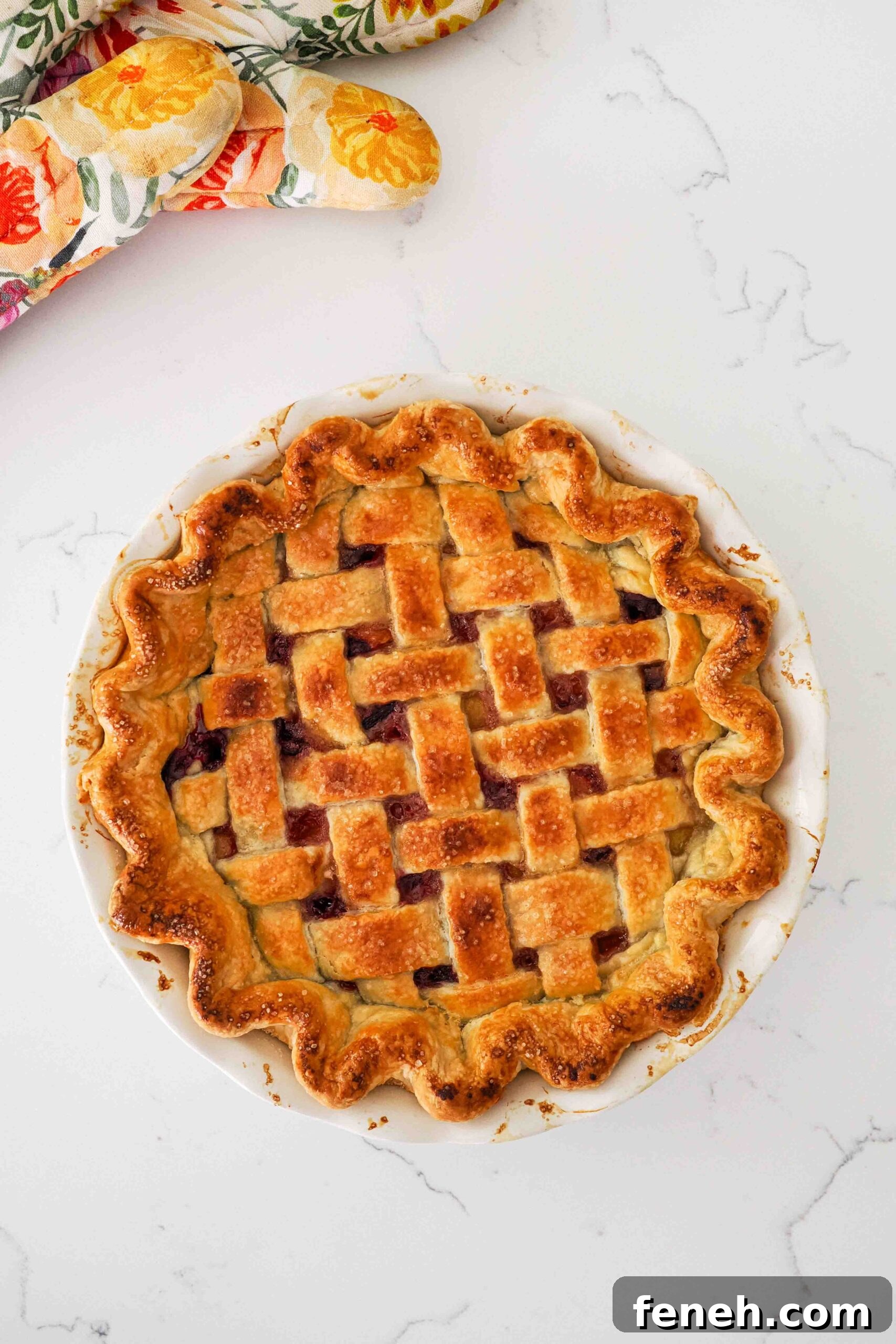 A fully baked and golden brown cherry lattice pie with almond extract.
