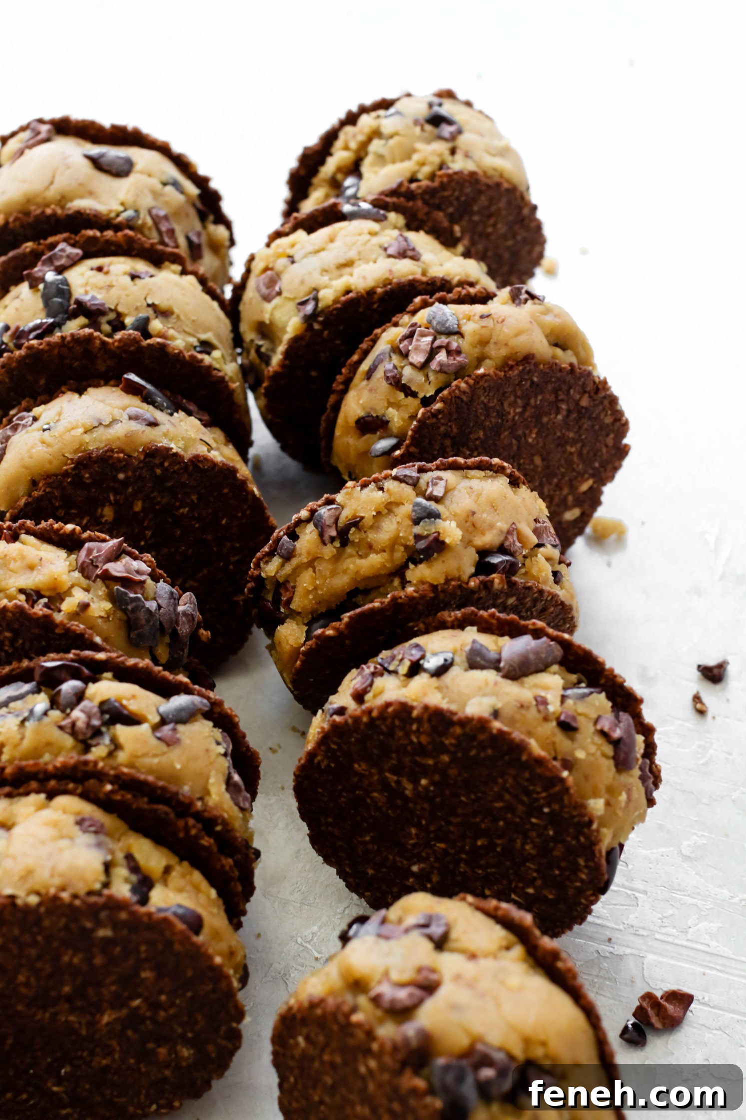 Cacao Chickpea Cookie Dough smashed between cookies and stacked 