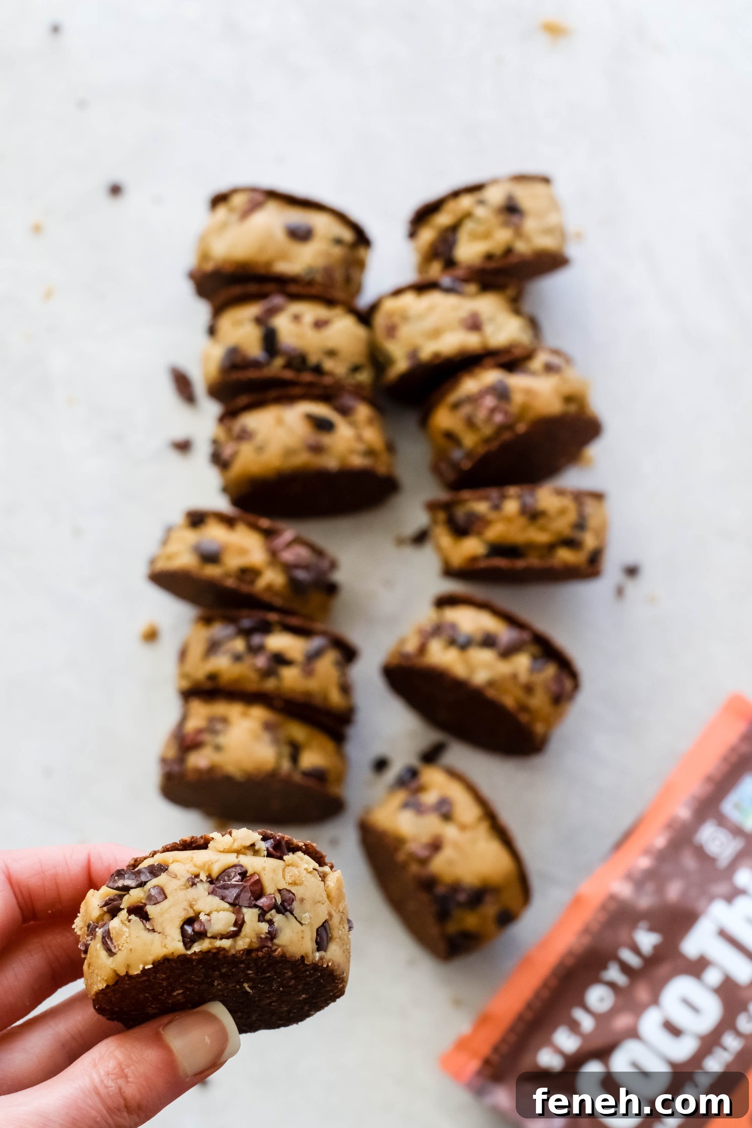 hand holding Cacao Chickpea Cookie Dough smashed between cookies