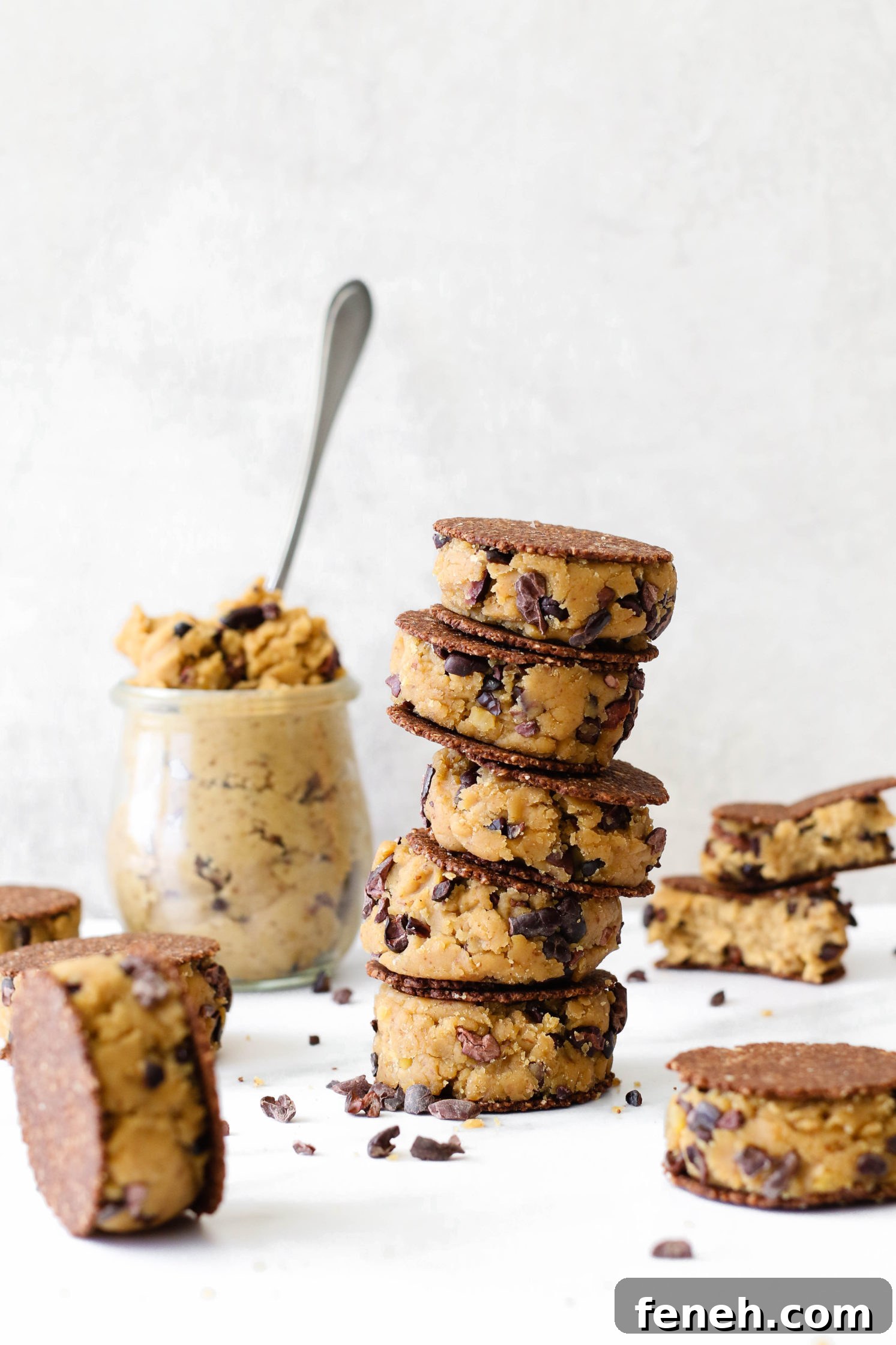 Cacao Chickpea Cookie Dough smashed between cookies and stacked 