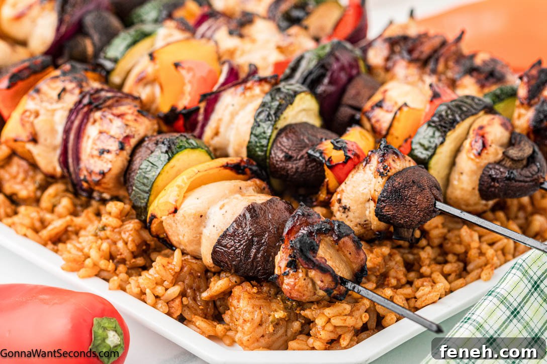 grilled chicken kebabs on top of rice