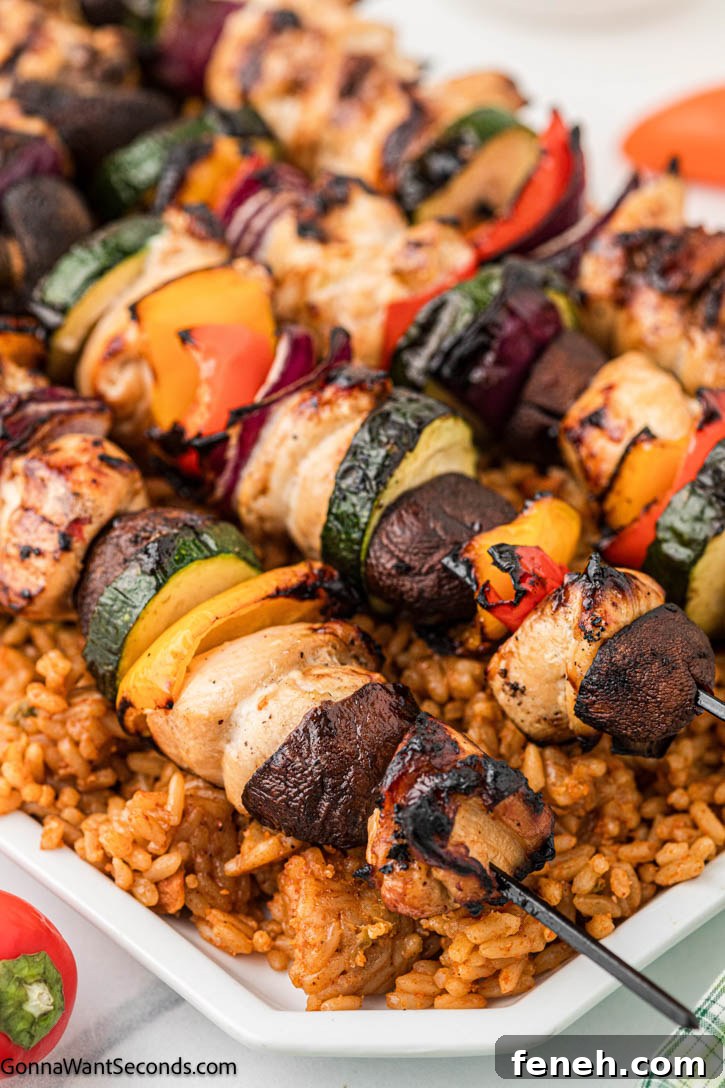 grilled chicken kebabs on top of rice