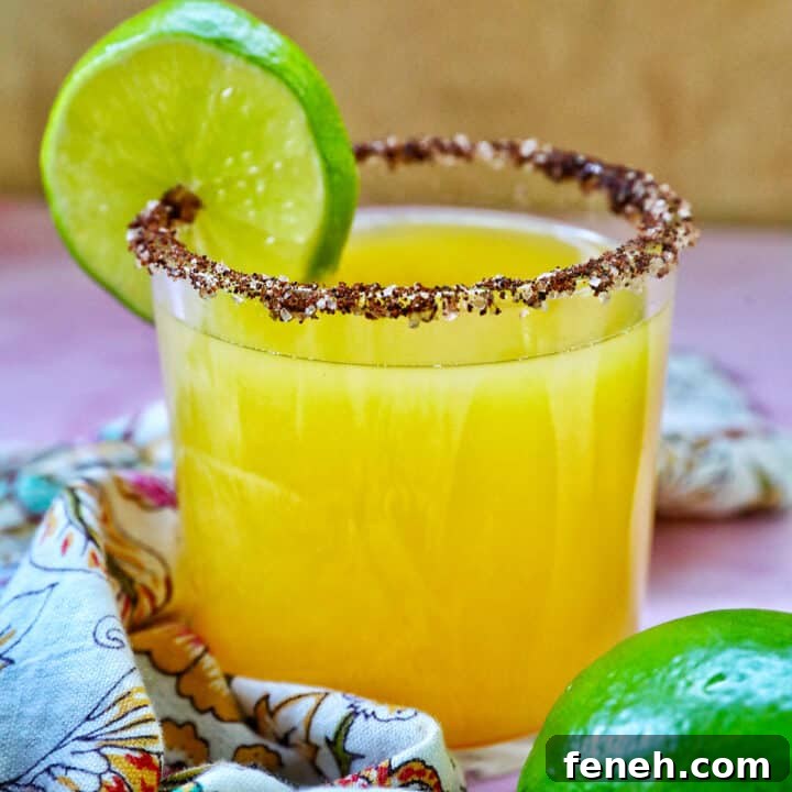 Spicy mango margarita with lime garnish