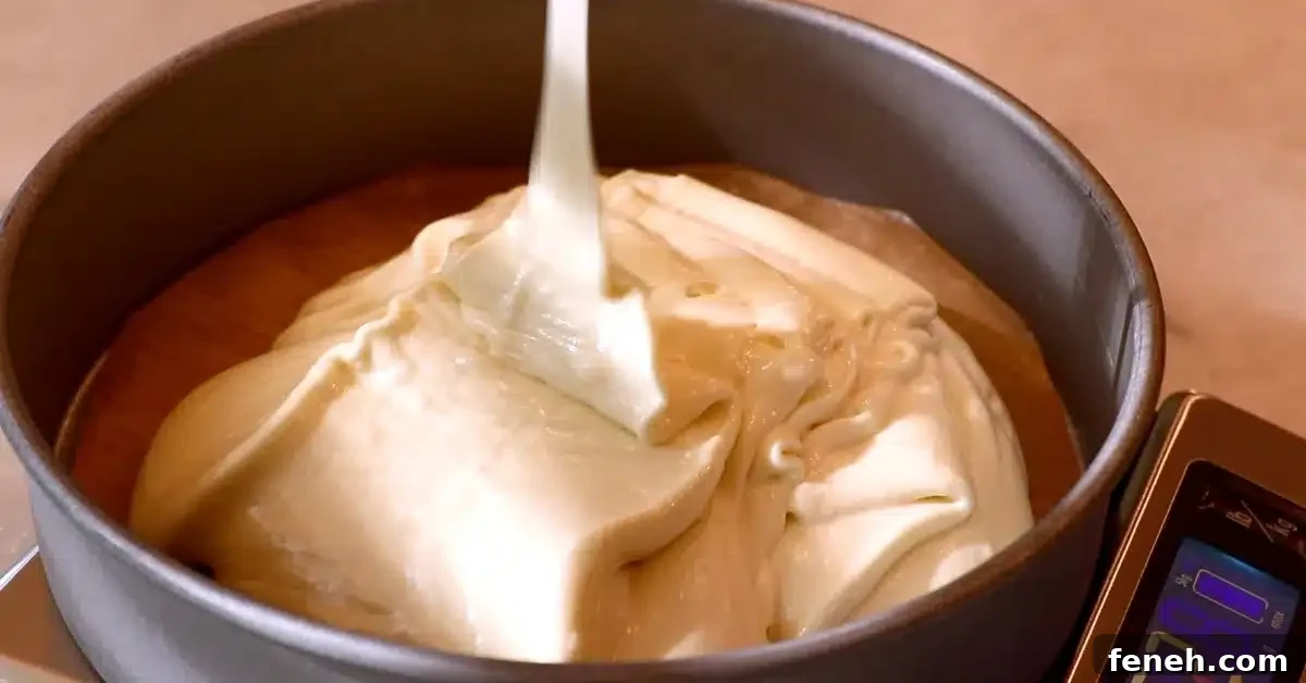 pouring vanilla cake batter into a pan