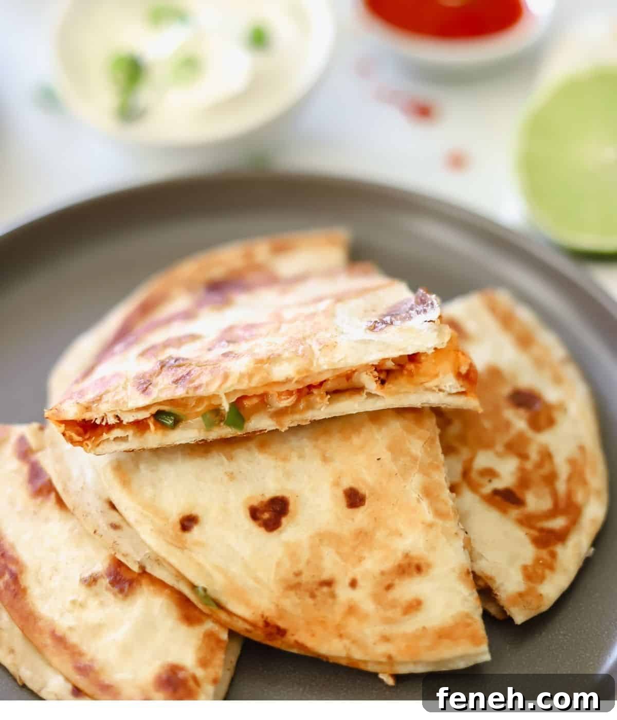 buffalo chicken quesadilla cut into fours on a gray plate