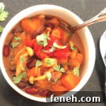 Hearty Vegan Butternut Squash Chili Recipe for Cozy Nights 4 Butternut Squash Chili in a bowl with sprig of cilantro t the side