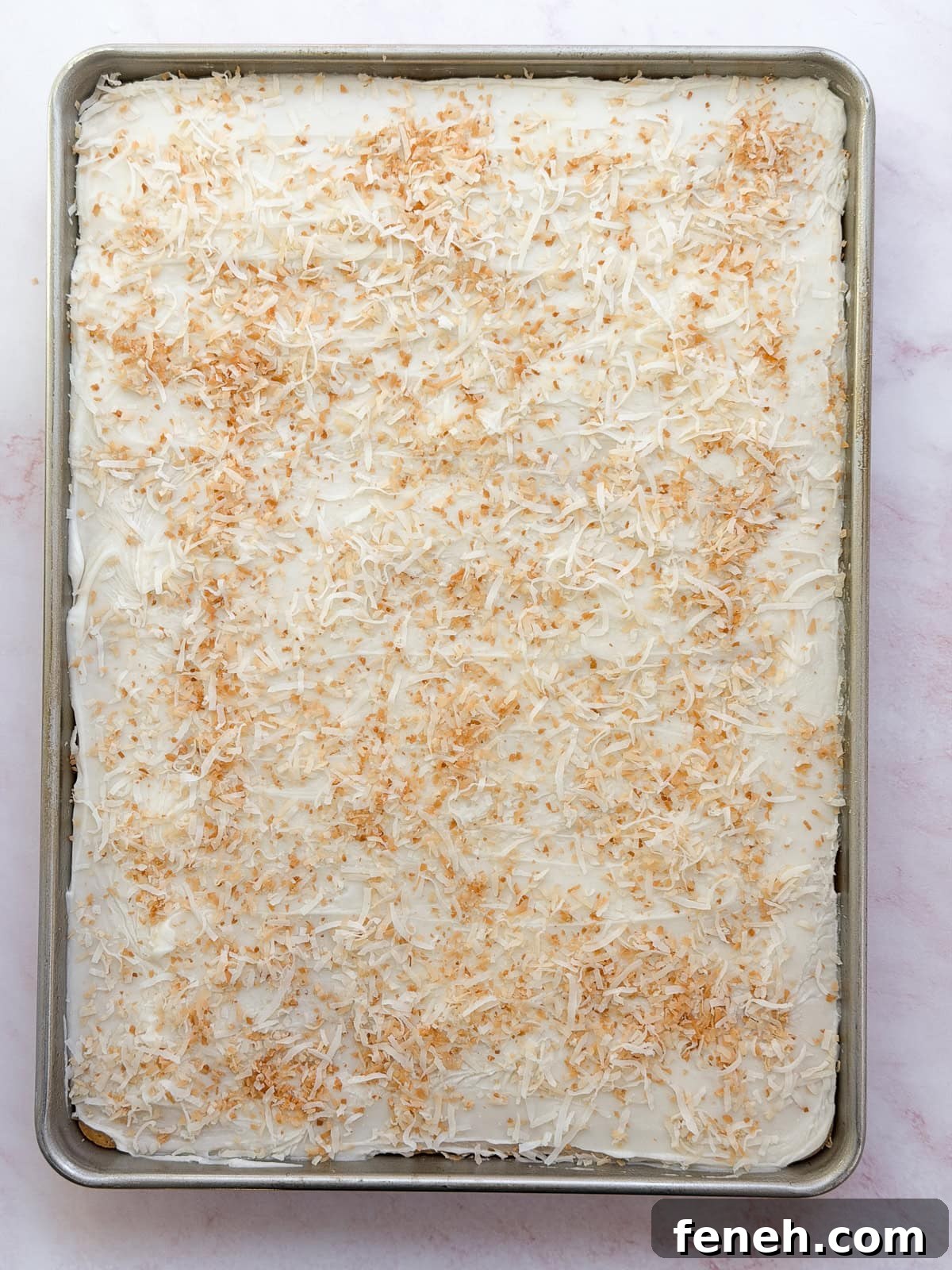 glaze and toasted coconut on top of cake.