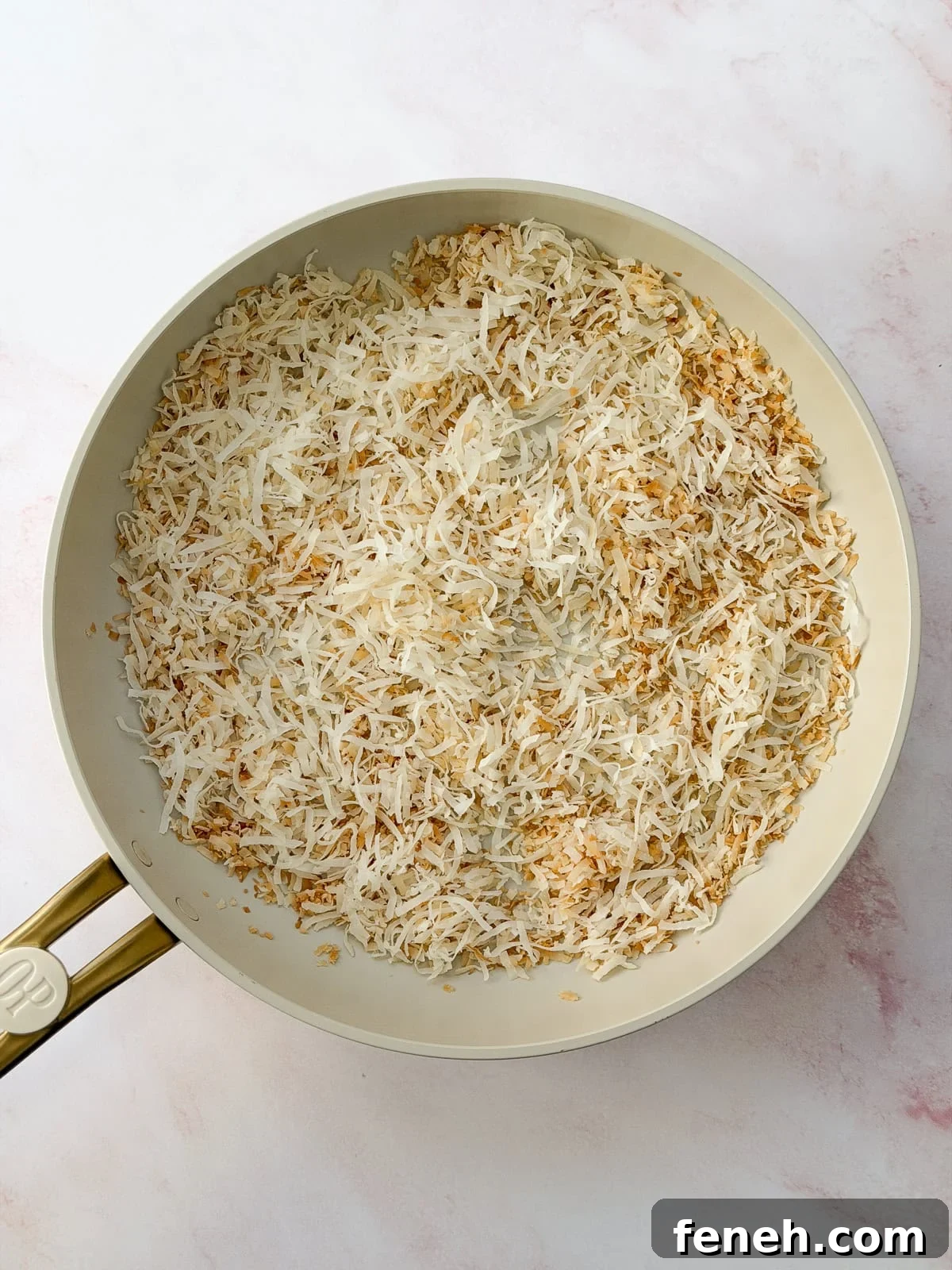 toasted coconut in a frying pan.