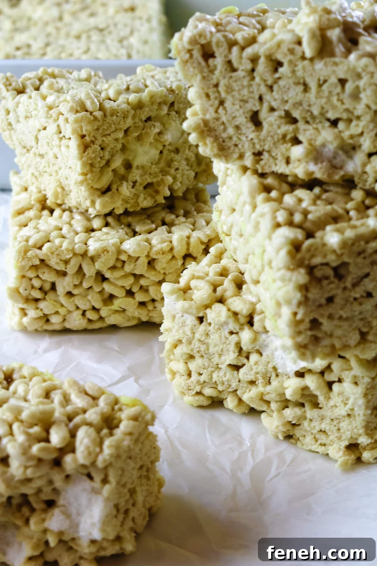 6 healthy rice krispie treats on white parchment paper.