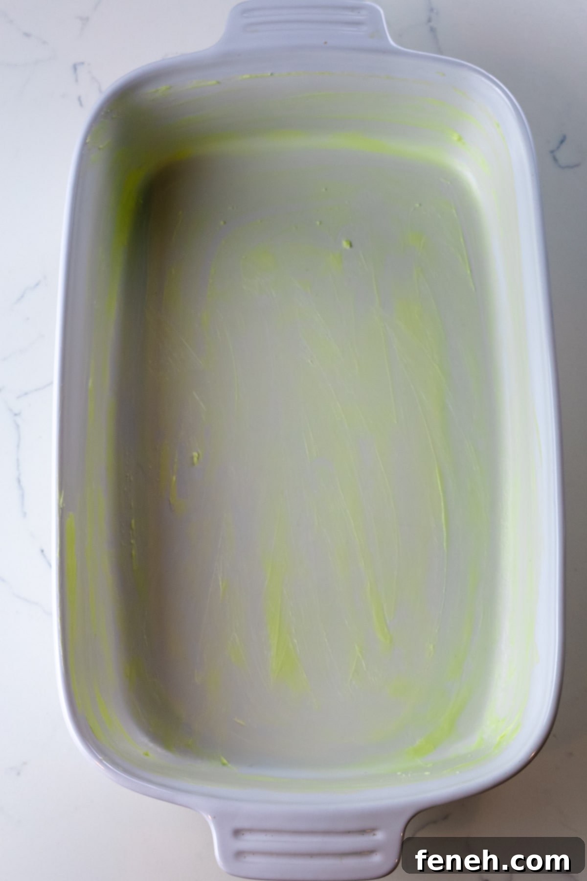 buttered pan on a white counter.