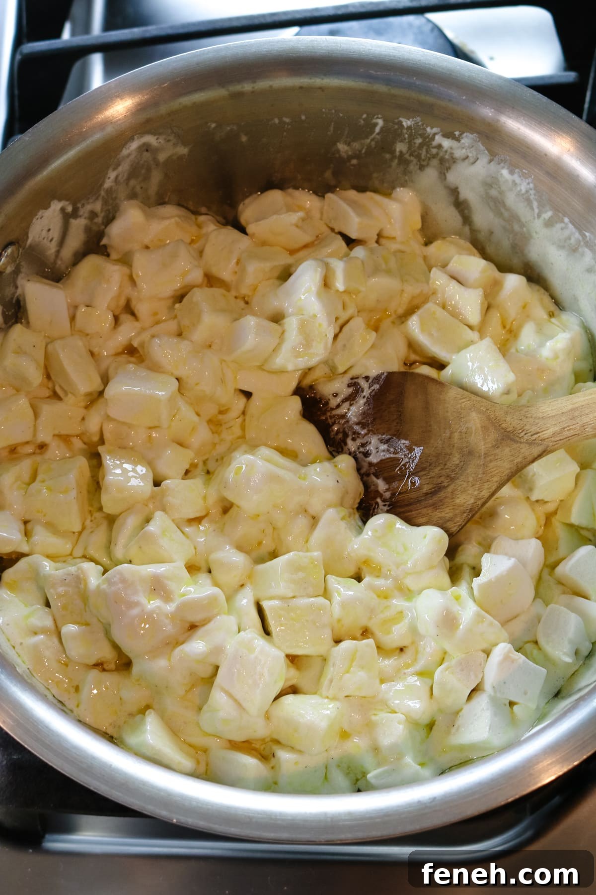 wooden spoon stirring melted marshmallows.