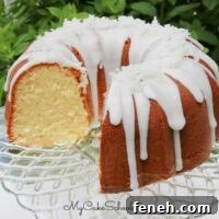 Moist coconut pound cake on a cake pedestal.