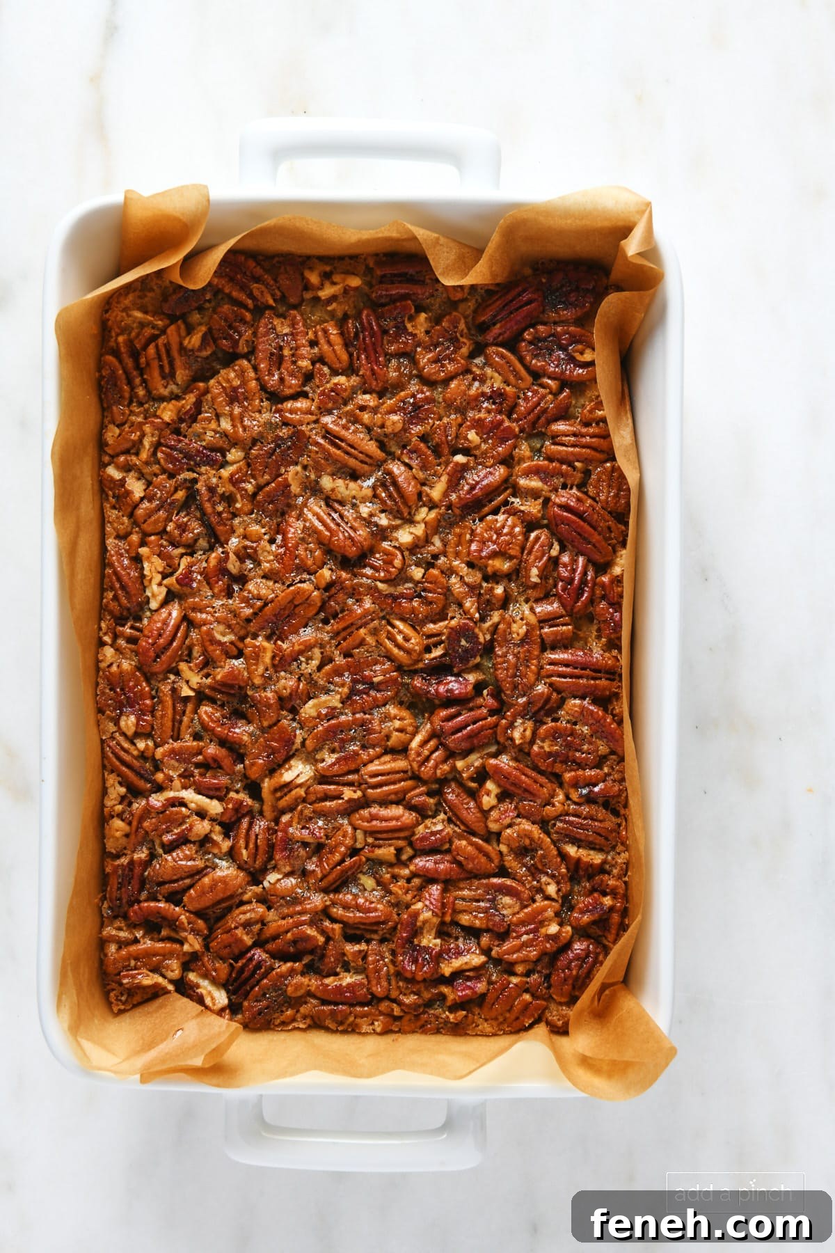Pecan pie bars in a baking dish.