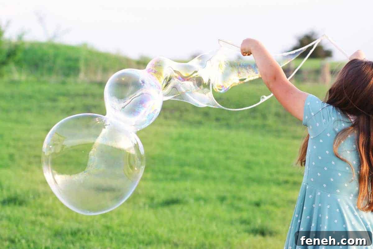 a girl making giant bubbles with a bubble wand