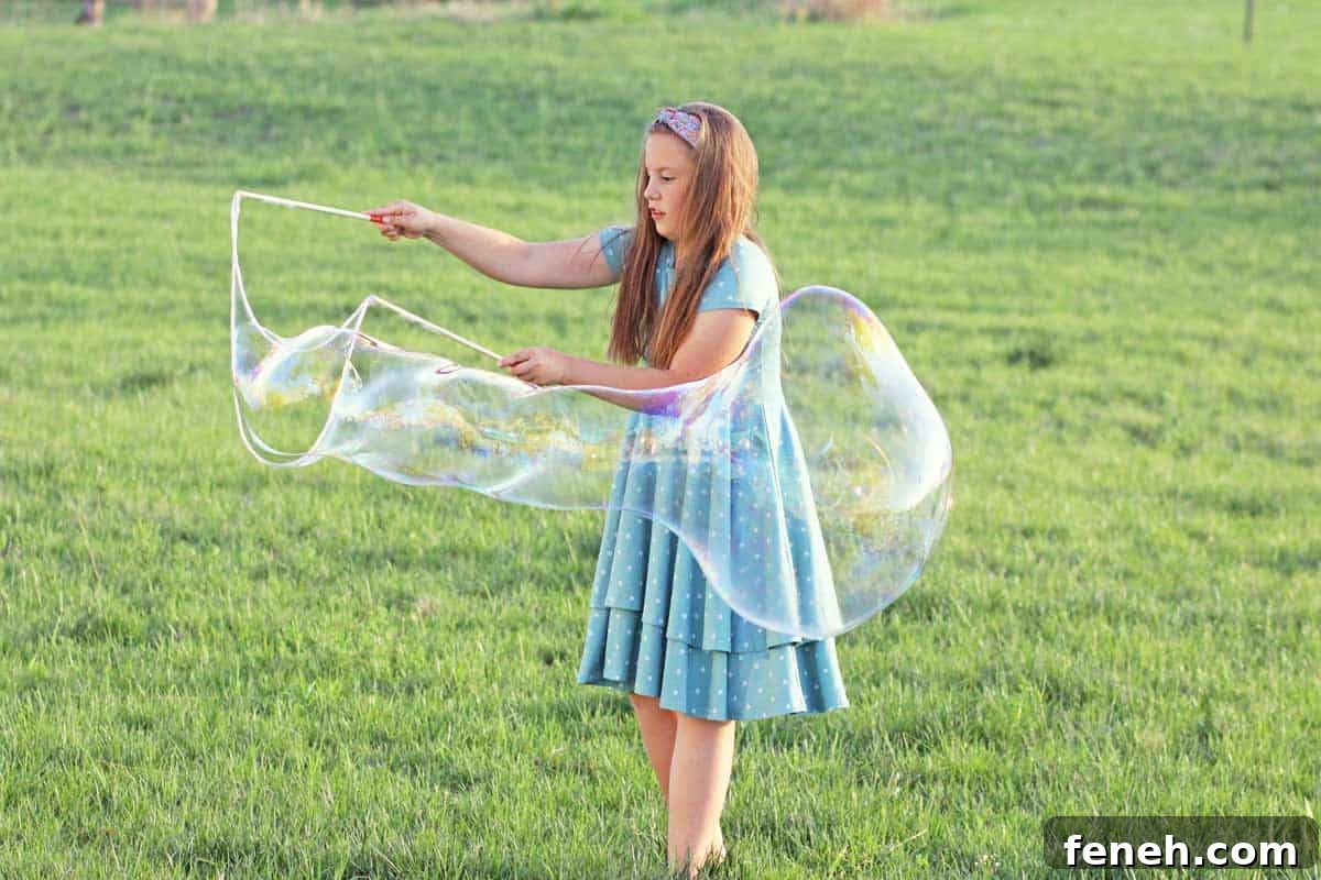 a girl making giant bubbles with a bubble wand