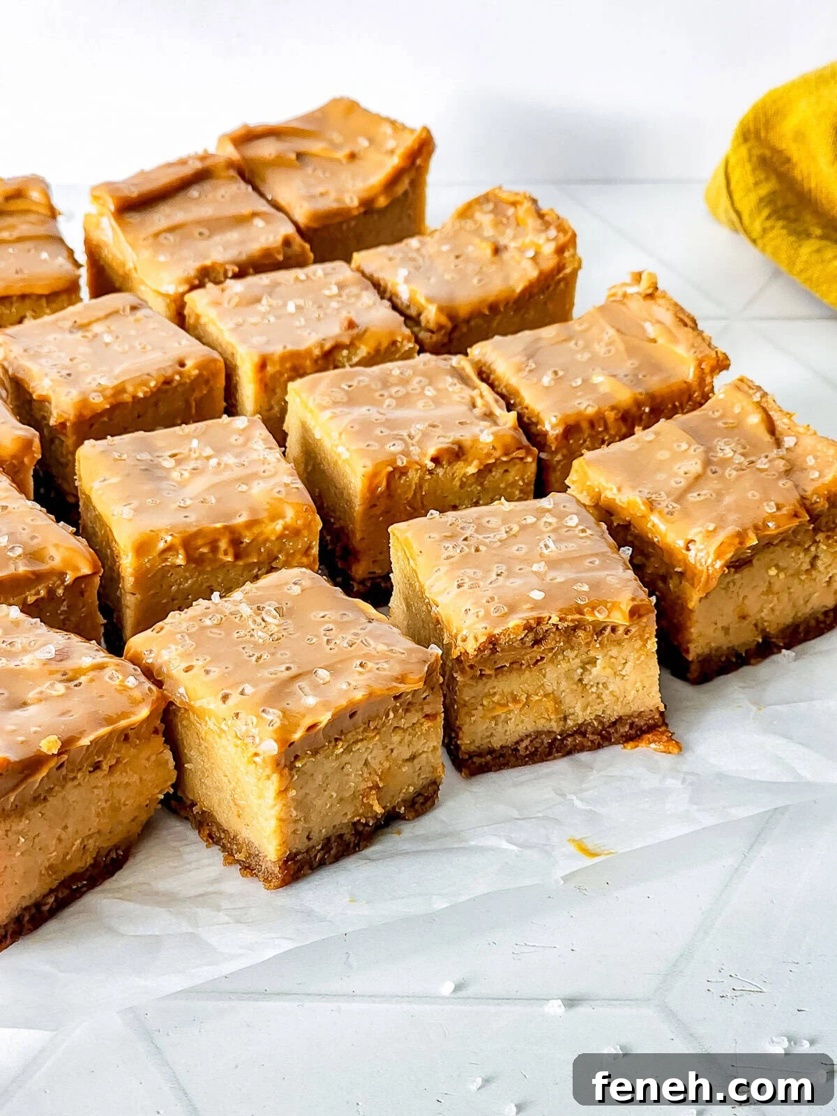 sliced up Dulce de Leche Cheesecake bites on parchment