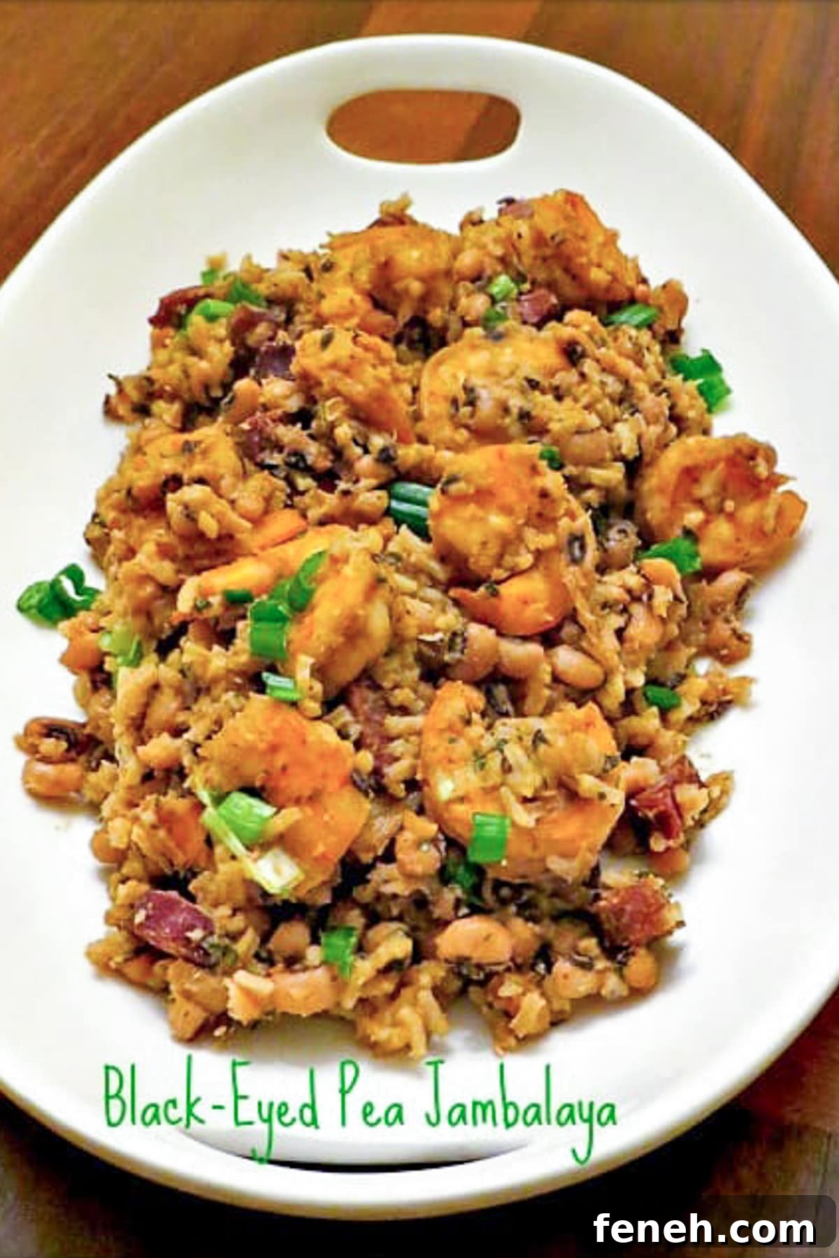 Black Eyed Pea Jambalaya is perfect for your New Year's Eve dinner! A meal that will start you off with good luck for the new year! black eyes pea jambalaya on white platter