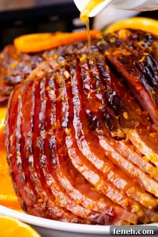 Drizzling glaze over slow cooker brown sugar ham.