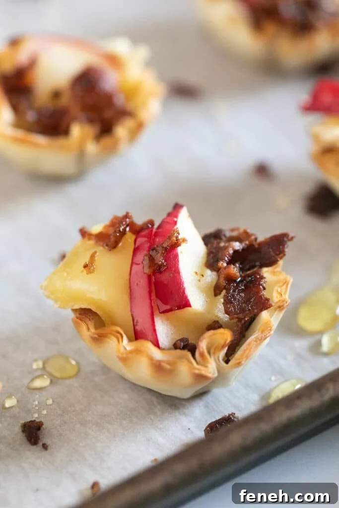 A close up image of a Brie Apple Phyllo Cup on a pan.