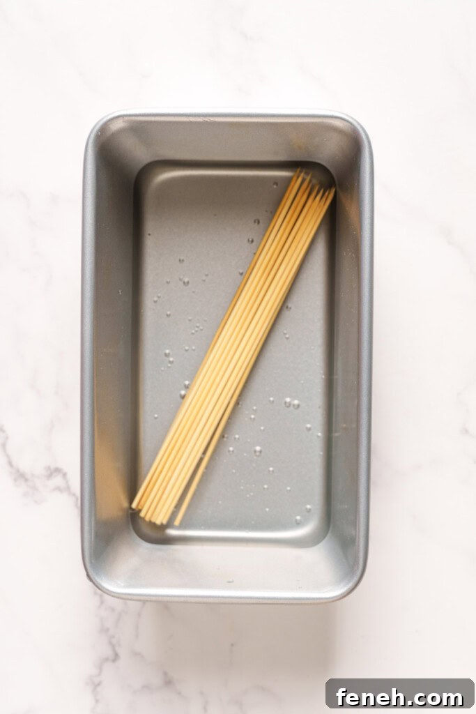 soaking bamboo skewers in a container.