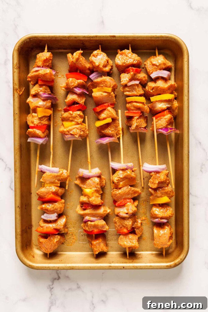 prepared chicken skewers on a sheet.