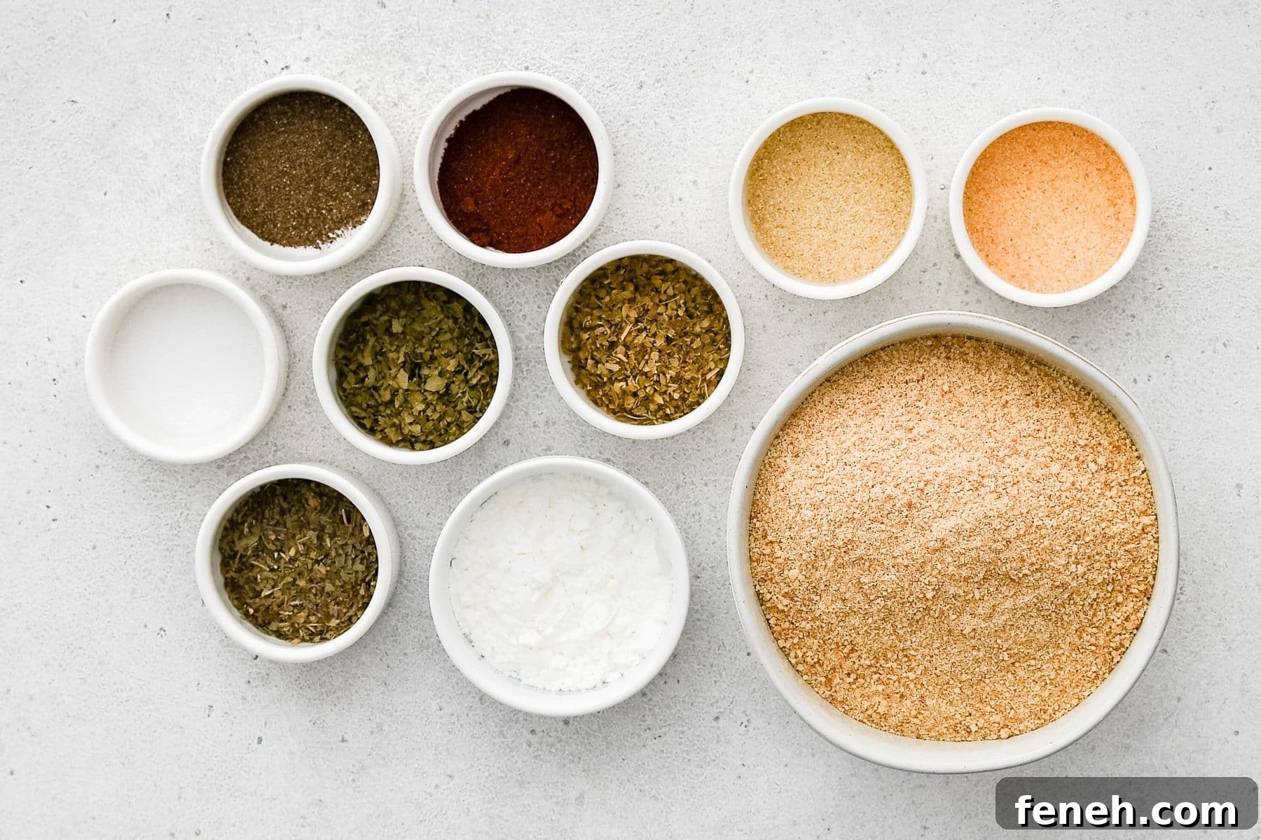 All of the ingredients needed to make homemade Shake and Bake in individual bowls, measuring cups, and ramekins.