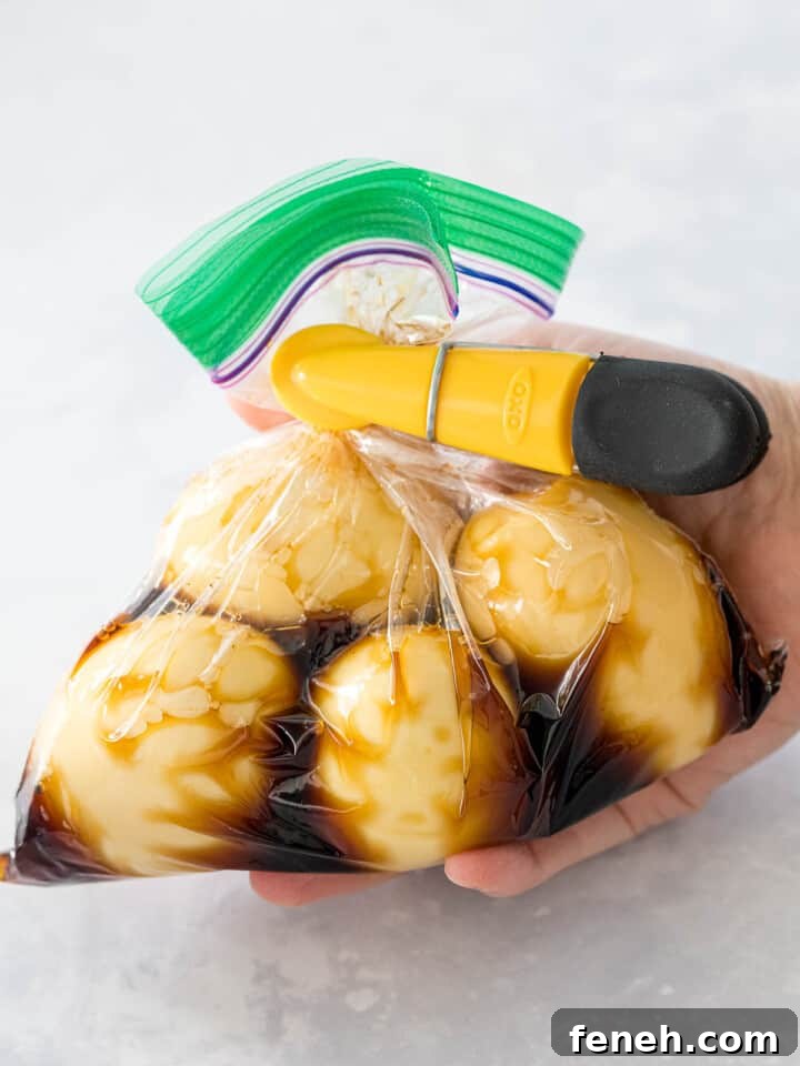 Soft boiled ramen eggs marinating in soy sauce and mirin in a plastic bag twisted closed..