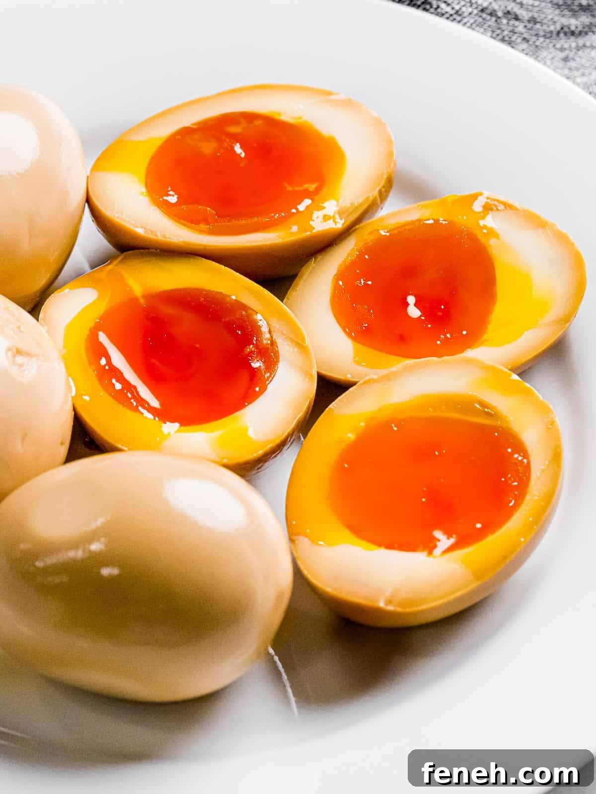 Ramen eggs or soy sauce eggs marinated in a soy mirin mixture that's been cut in half to show jammy yolk.