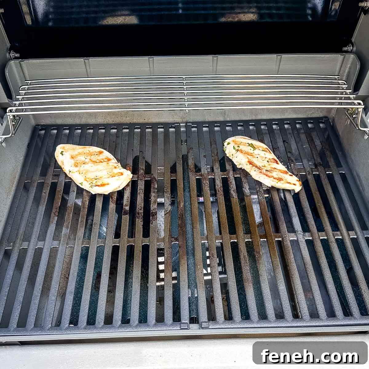 Chicken grilling on a gas grill.