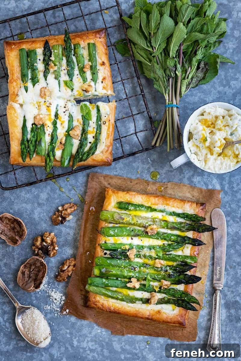 Two puff pastry tarts topped with asparagus