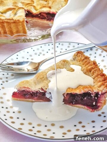 A jug of cream being poured over a slice of pie.