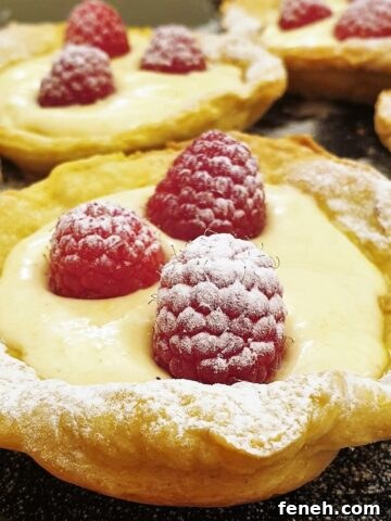 Tray of raspberry custard tarts.