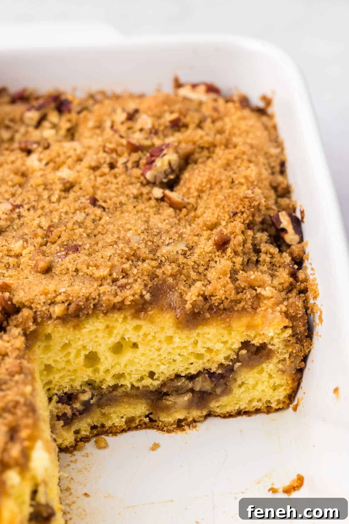 The cake in a pan with slices cut out.