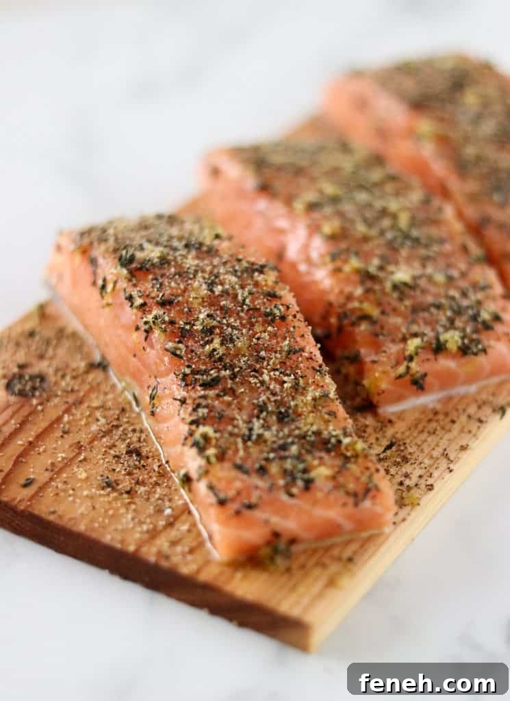 A close up of salmon filets on a cedar plank