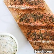 Salmon filets on a cedar plank with a creamy sauce